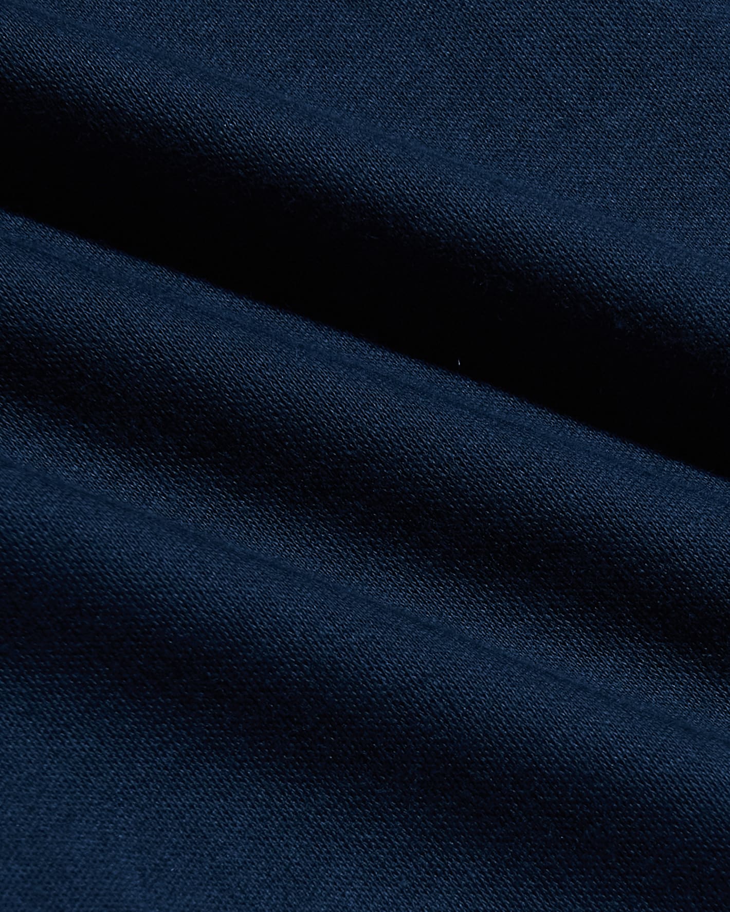 Close-up of soft navy fabric texture showing fine knit detail and subtle folds of the Navy Pima Cotton Blend Crew men's basics garment.
