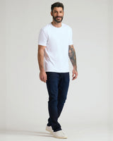 Man wearing Pima Cotton Blend Crew 4-Pack T-shirt, jeans, sneakers.